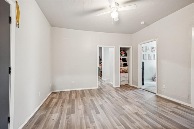 334 SE 24th St, Oklahoma City, OK 73129 - unfurnished bedroom with light wood finished floors, a closet, ceiling fan, and a spacious closet