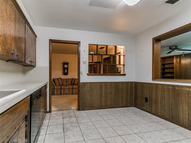 2120 N Divis Ave, Bethany, OK 73008 - kitchen featuring ceiling fan, wainscoting, dishwasher, wood walls, and light countertops