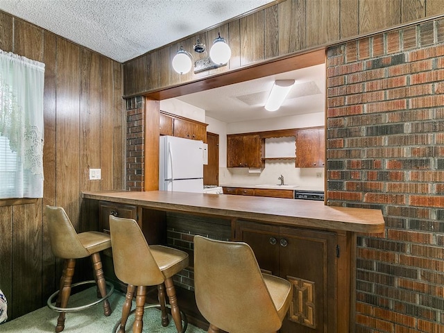 2120 N Divis Ave, Bethany, OK 73008 - bar with freestanding refrigerator, wood walls, dishwasher, and a textured ceiling