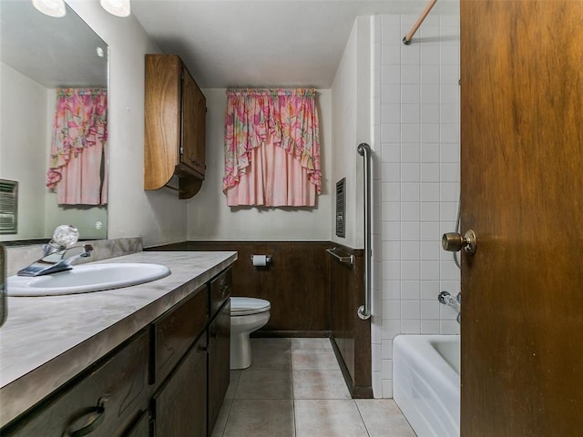 2120 N Divis Ave, Bethany, OK 73008 - bathroom with vanity, tile patterned flooring, wainscoting, and shower / washtub combination