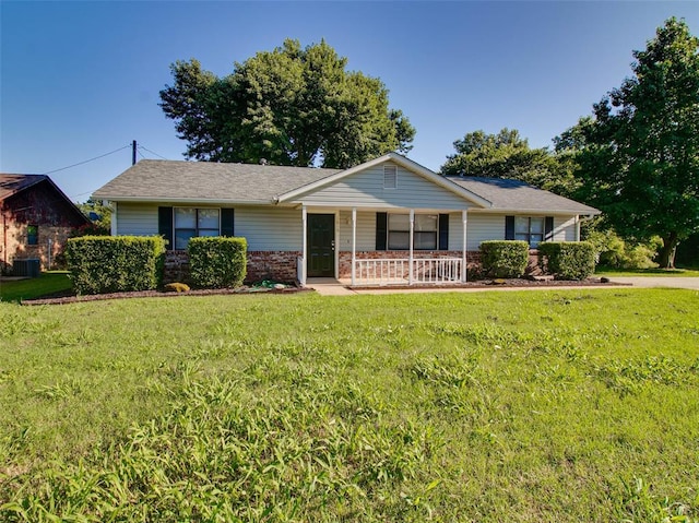 1810 Spring Ave, Stroud, OK 74079 - single story home with a porch, a front yard, and brick siding