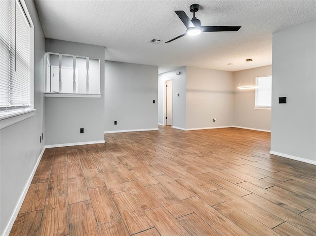 1810 Spring Ave, Stroud, OK 74079 - unfurnished room with ceiling fan, light wood-type flooring, and a textured ceiling
