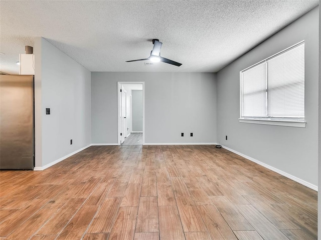 1810 Spring Ave, Stroud, OK 74079 - unfurnished room featuring a ceiling fan, light wood-style floors, and a textured ceiling