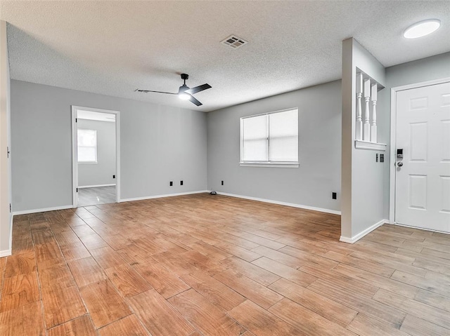 1810 Spring Ave, Stroud, OK 74079 - empty room with ceiling fan, a textured ceiling, and light wood-style flooring