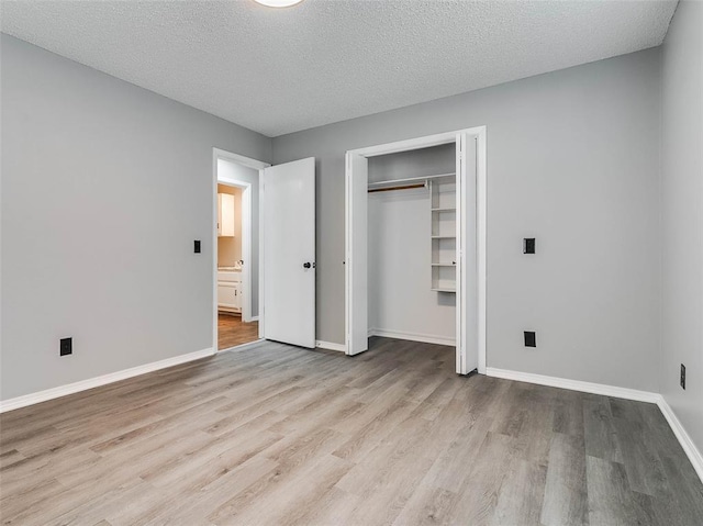 1810 Spring Ave, Stroud, OK 74079 - unfurnished bedroom featuring wood finished floors, a textured ceiling, and a closet