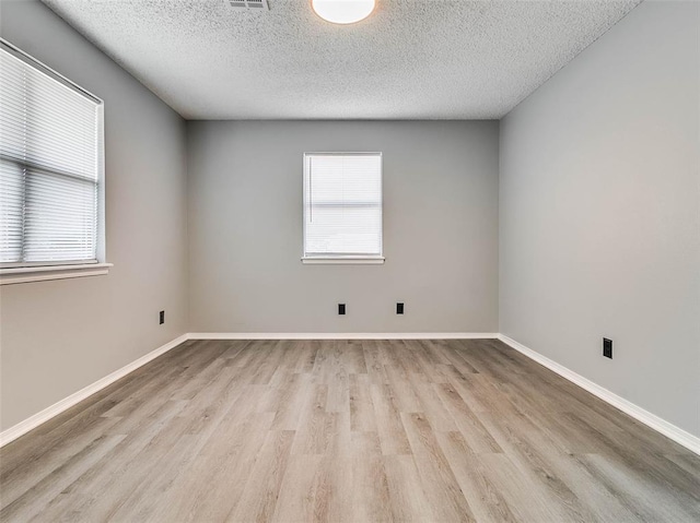 1810 Spring Ave, Stroud, OK 74079 - unfurnished room with wood finished floors and a textured ceiling
