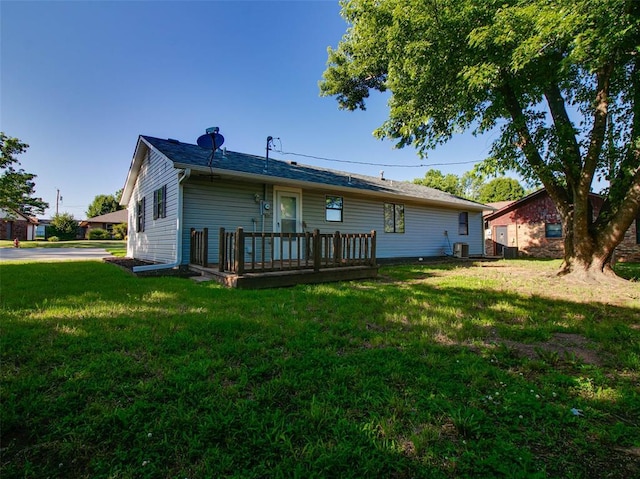 1810 Spring Ave, Stroud, OK 74079 - rear view of house with a lawn and a wooden deck