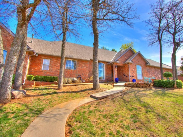 2404 Pawnee Xing, Edmond, OK 73034 - single story home featuring brick siding, a front yard, and roof with shingles