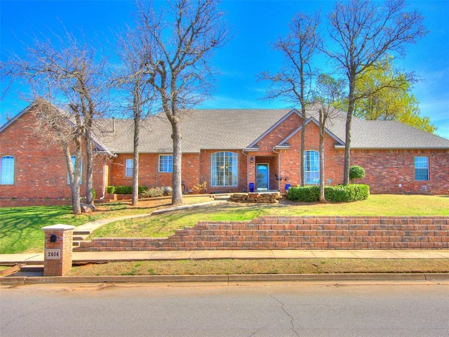 2404 Pawnee Xing, Edmond, OK 73034 - single story home with brick siding and a front lawn