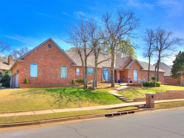 2404 Pawnee Xing, Edmond, OK 73034 - view of front of house with brick siding and a front lawn