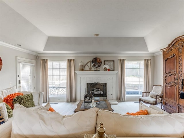 2404 Pawnee Xing, Edmond, OK 73034 - living room with a raised ceiling, a tiled fireplace, and ornamental molding