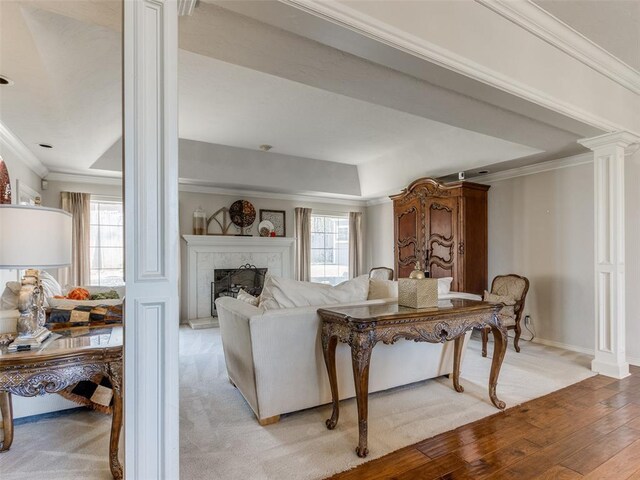 2404 Pawnee Xing, Edmond, OK 73034 - living room with decorative columns, plenty of natural light, a tile fireplace, crown molding, and light wood finished floors