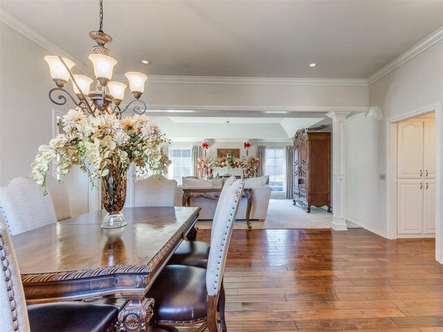 2404 Pawnee Xing, Edmond, OK 73034 - dining area with crown molding, wood-type flooring, a chandelier, recessed lighting, and ornate columns