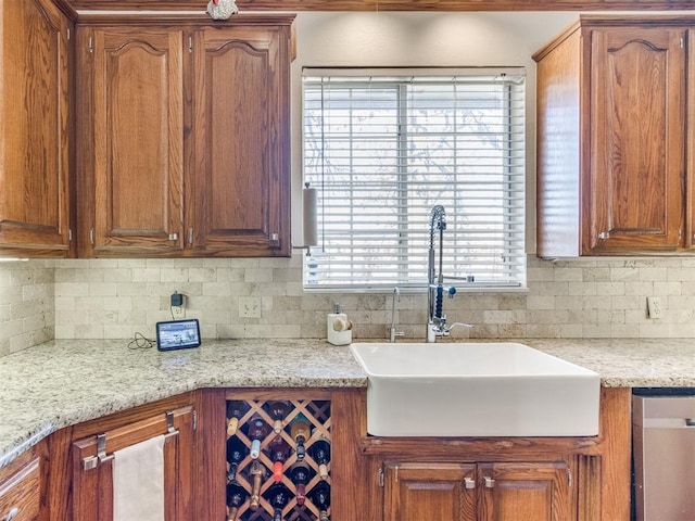 2404 Pawnee Xing, Edmond, OK 73034 - kitchen featuring decorative backsplash, stainless steel dishwasher, and brown cabinets