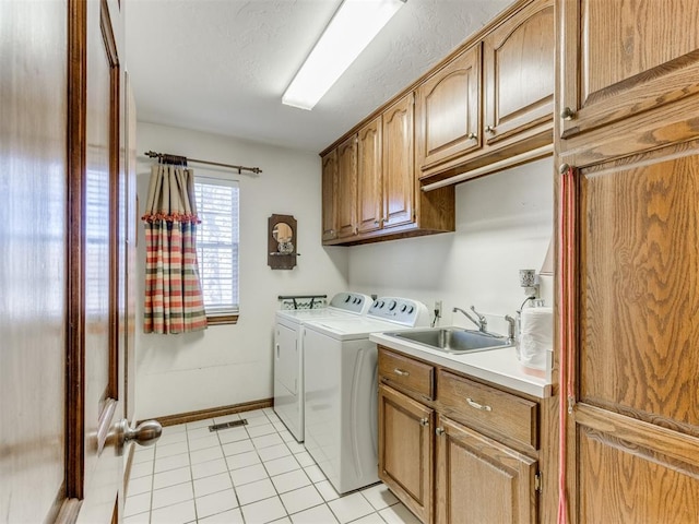 2404 Pawnee Xing, Edmond, OK 73034 - washroom featuring washer and dryer, cabinet space, and light tile patterned floors