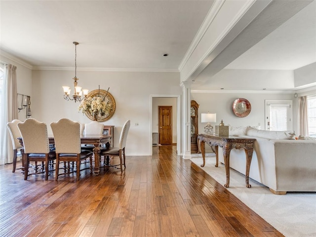 2404 Pawnee Xing, Edmond, OK 73034 - dining room featuring hardwood / wood-style floors, a chandelier, and crown molding