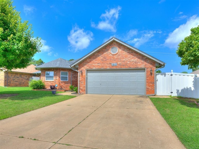 1917 Goldenrod Ln, Midwest City, OK 73130 - view of front of home with brick siding, concrete driveway, and a garage