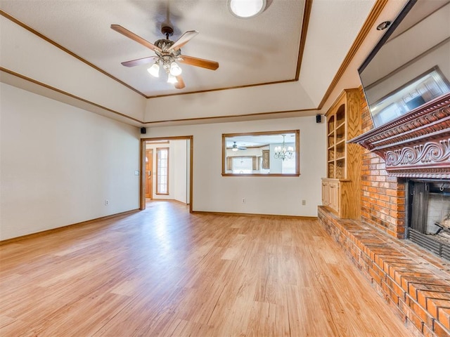 1917 Goldenrod Ln, Midwest City, OK 73130 - unfurnished living room featuring light wood-style flooring, a ceiling fan, a fireplace, healthy amount of natural light, and crown molding