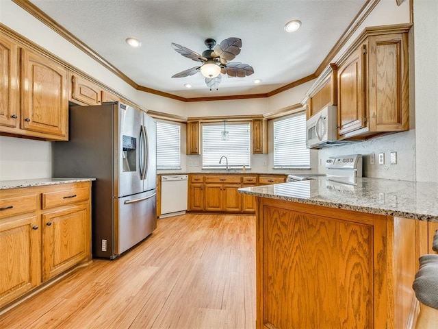 1917 Goldenrod Ln, Midwest City, OK 73130 - kitchen featuring white appliances, a peninsula, ornamental molding, light wood finished floors, and a ceiling fan