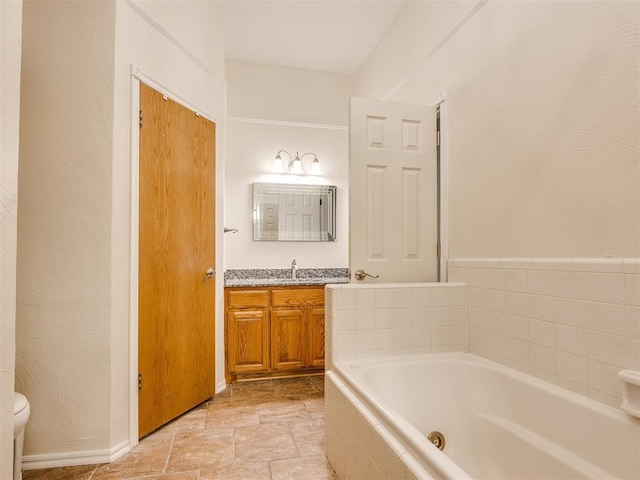 1917 Goldenrod Ln, Midwest City, OK 73130 - bathroom with a jetted tub, vanity, and stone finish flooring