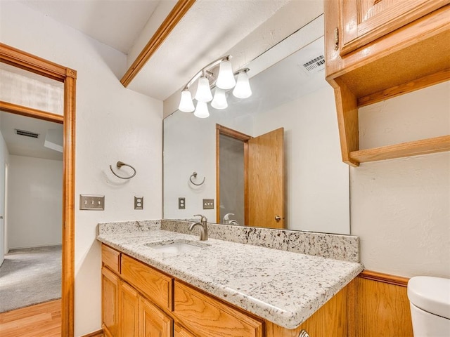1917 Goldenrod Ln, Midwest City, OK 73130 - bathroom with vanity and wood finished floors