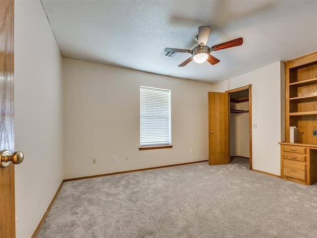 1917 Goldenrod Ln, Midwest City, OK 73130 - unfurnished bedroom featuring light colored carpet, a textured ceiling, and a ceiling fan