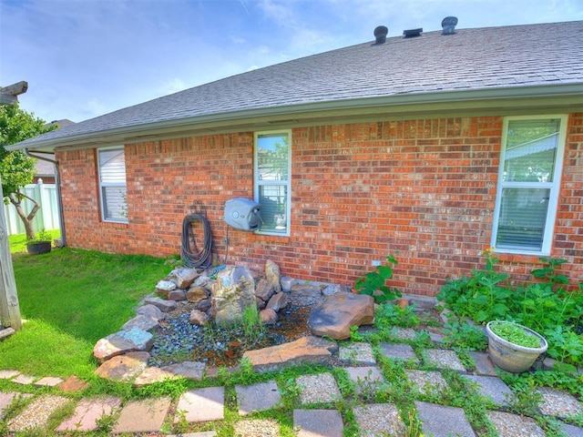 1917 Goldenrod Ln, Midwest City, OK 73130 - back of property with brick siding, a lawn, and a shingled roof
