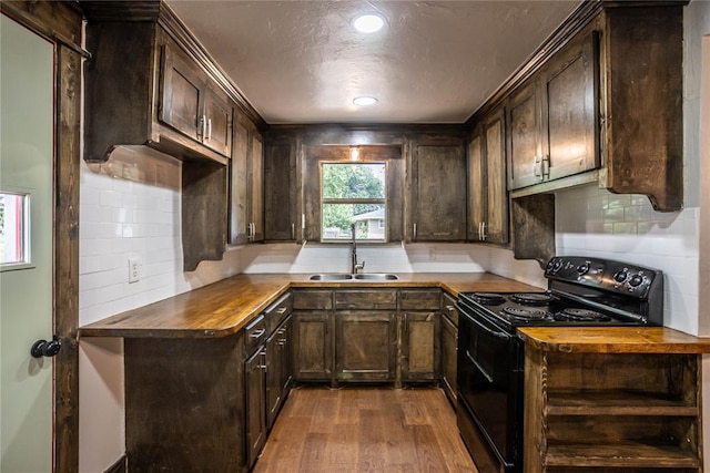 103 E Ash St, Carnegie, OK 73015 - kitchen with black / electric stove, dark wood-style flooring, dark brown cabinetry, decorative backsplash, and a textured ceiling