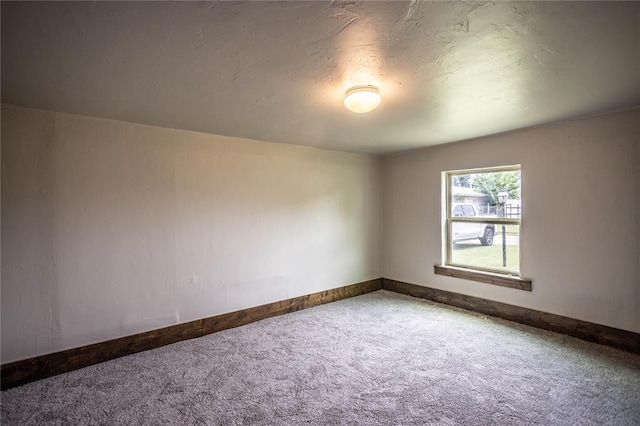 103 E Ash St, Carnegie, OK 73015 - empty room with carpet and baseboards