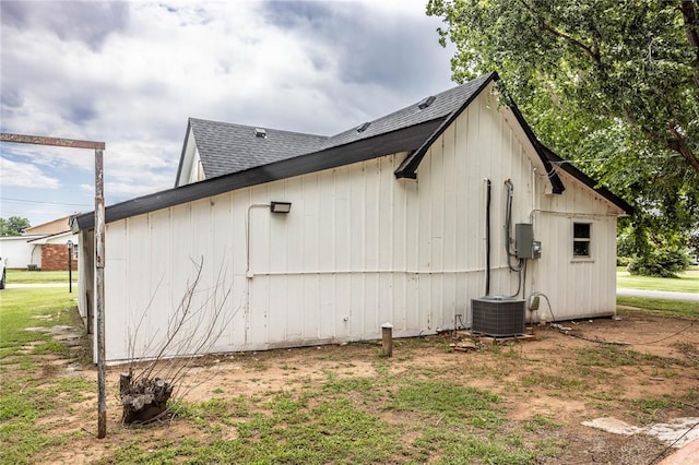 103 E Ash St, Carnegie, OK 73015 - view of home's exterior featuring a cooling unit and roof with shingles