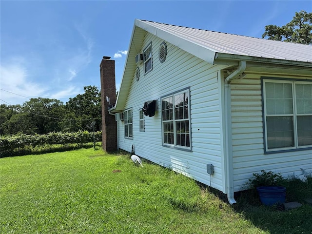 12237 N 359th Rd, Seminole, OK 74868 - view of side of home with a lawn, a metal roof, and a chimney