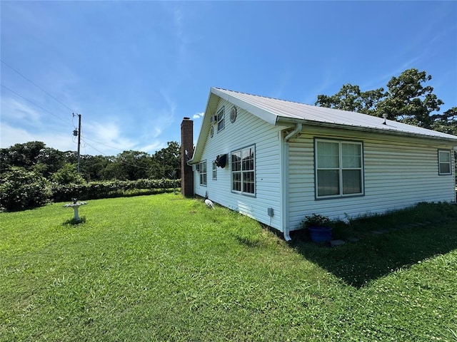 12237 N 359th Rd, Seminole, OK 74868 - view of side of home featuring a yard, a metal roof, and a chimney