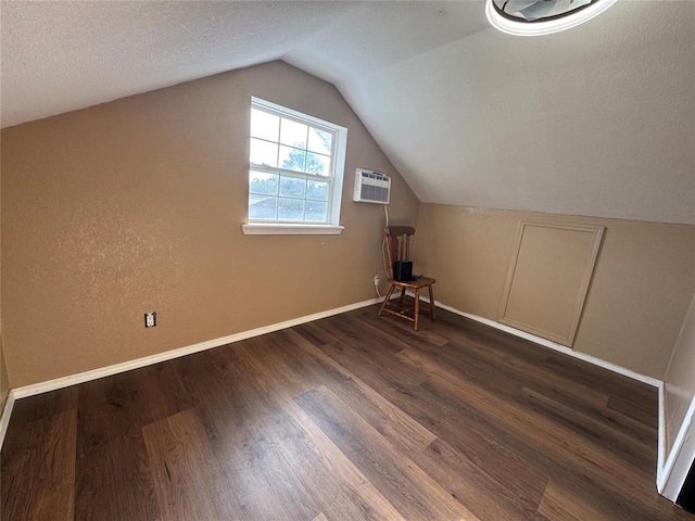 12237 N 359th Rd, Seminole, OK 74868 - additional living space with an AC wall unit, dark wood-style floors, and lofted ceiling