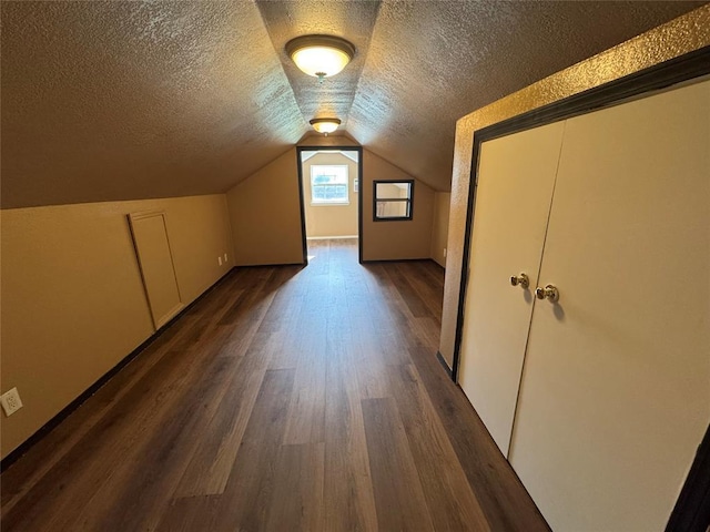 12237 N 359th Rd, Seminole, OK 74868 - additional living space featuring dark wood-style floors, a textured ceiling, and lofted ceiling