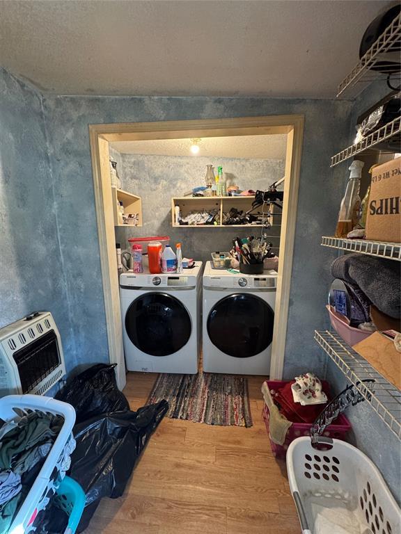 12237 N 359th Rd, Seminole, OK 74868 - washroom featuring washing machine and clothes dryer and wood finished floors