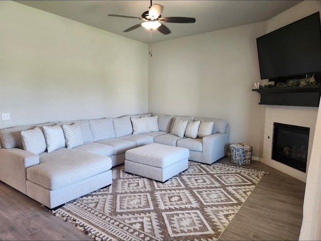 10812 NW 5th St, Yukon, OK 73099 - living area with wood finished floors, a ceiling fan, and a glass covered fireplace