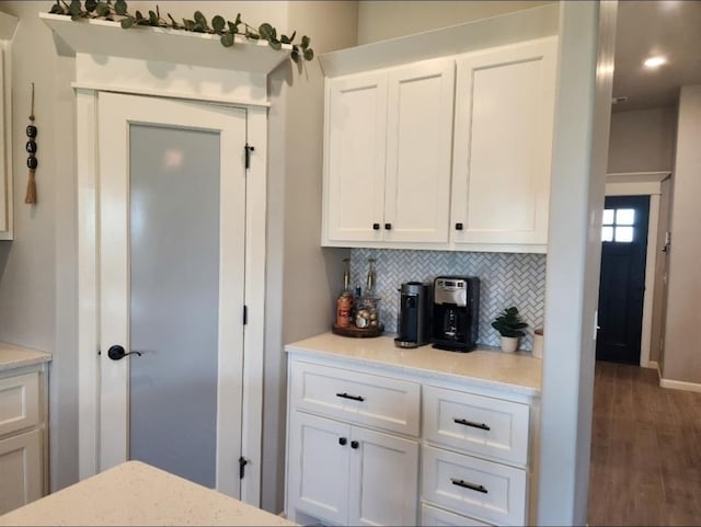 10812 NW 5th St, Yukon, OK 73099 - kitchen featuring white cabinetry, backsplash, wood finished floors, light stone countertops, and recessed lighting
