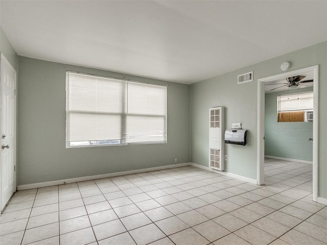 506 SW 24th St, Oklahoma City, OK 73109 - empty room with a heating unit, healthy amount of natural light, a smoke detector, and light tile patterned flooring
