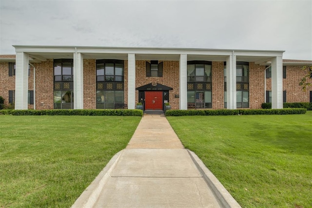 2527 NW 62nd St Unit 214, Oklahoma City, OK 73112 - property entrance with brick siding and a lawn