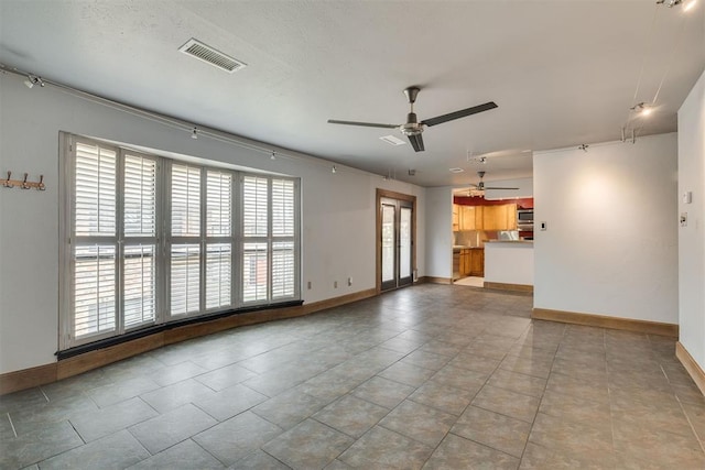 2527 NW 62nd St Unit 214, Oklahoma City, OK 73112 - unfurnished living room featuring a ceiling fan and light tile patterned flooring