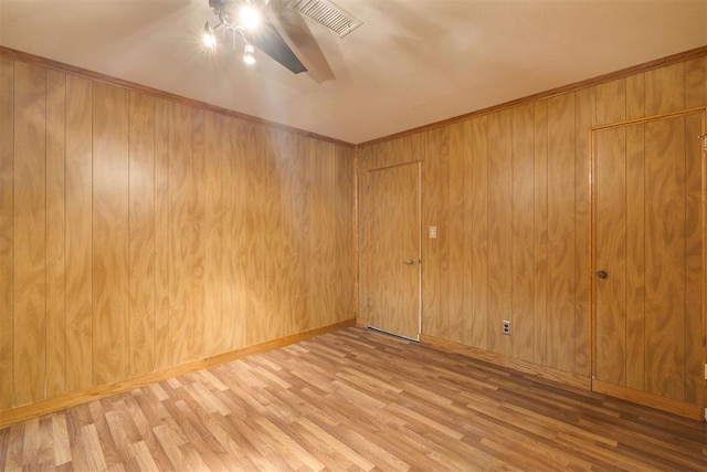 2527 NW 62nd St Unit 214, Oklahoma City, OK 73112 - spare room featuring ceiling fan, wood finished floors, and wood walls