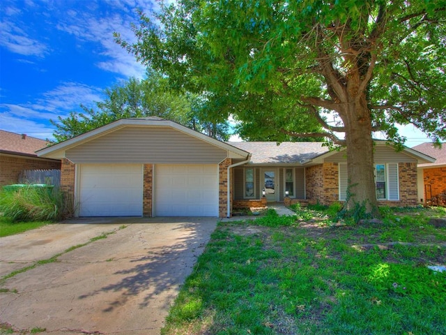 804 Royal Ln, Yukon, OK 73099 - view of front of home featuring an attached garage, concrete driveway, and brick siding