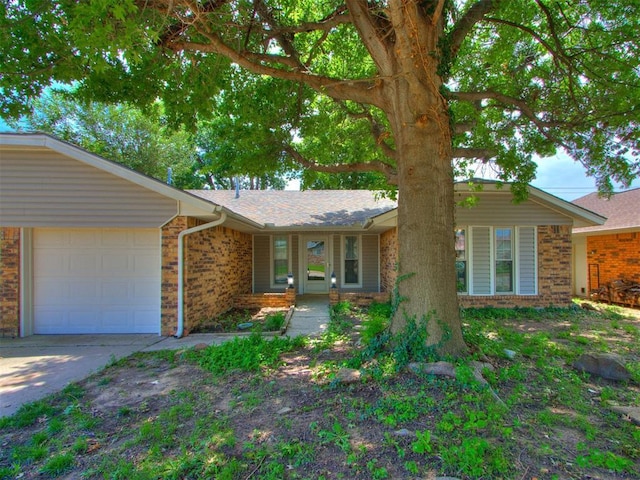 804 Royal Ln, Yukon, OK 73099 - ranch-style house with brick siding, an attached garage, and concrete driveway