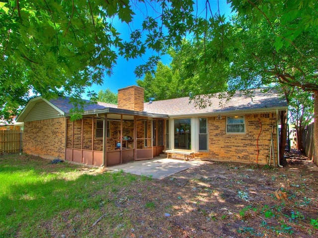804 Royal Ln, Yukon, OK 73099 - back of property with a patio, brick siding, a chimney, and a sunroom
