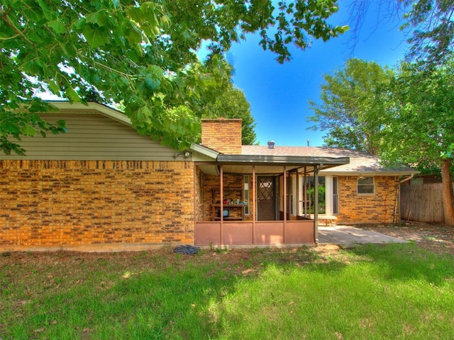 804 Royal Ln, Yukon, OK 73099 - back of property featuring brick siding, a chimney, and a patio