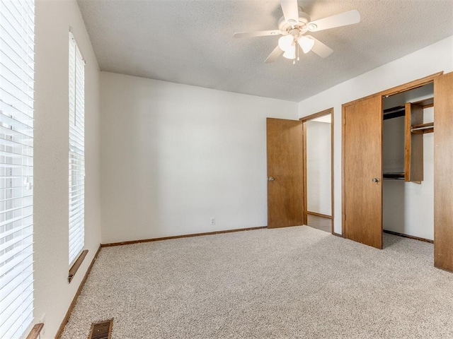 804 Royal Ln, Yukon, OK 73099 - unfurnished bedroom featuring carpet floors, a textured ceiling, a closet, and ceiling fan