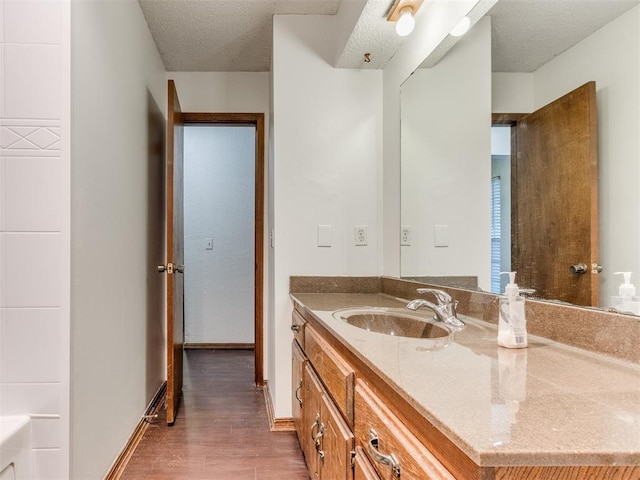 804 Royal Ln, Yukon, OK 73099 - bathroom with vanity, wood finished floors, and a textured ceiling