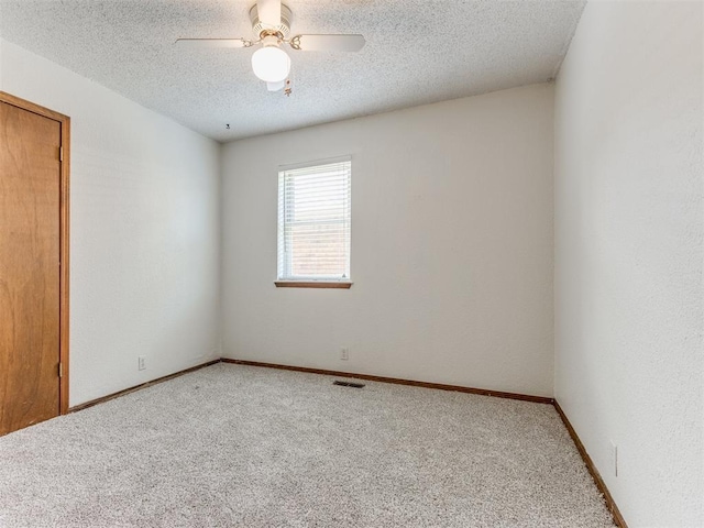 804 Royal Ln, Yukon, OK 73099 - spare room featuring carpet floors, a textured ceiling, and ceiling fan