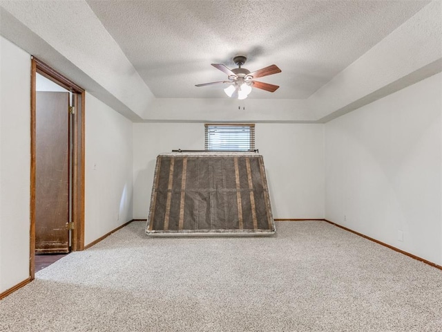804 Royal Ln, Yukon, OK 73099 - unfurnished room featuring carpet floors, ceiling fan, a raised ceiling, and a textured ceiling