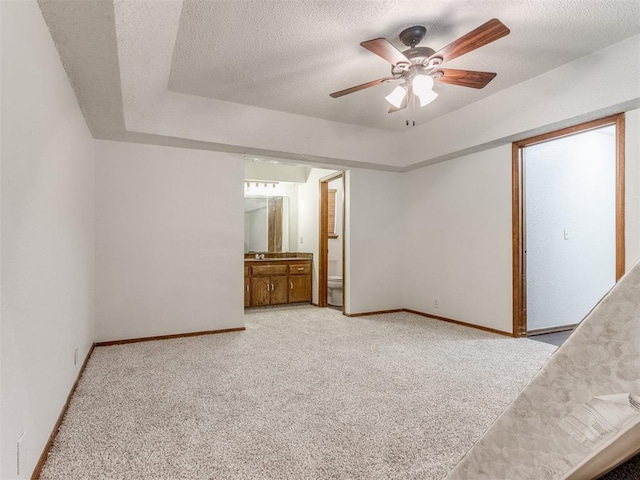 804 Royal Ln, Yukon, OK 73099 - unfurnished bedroom featuring light colored carpet, a textured ceiling, ensuite bathroom, and a ceiling fan